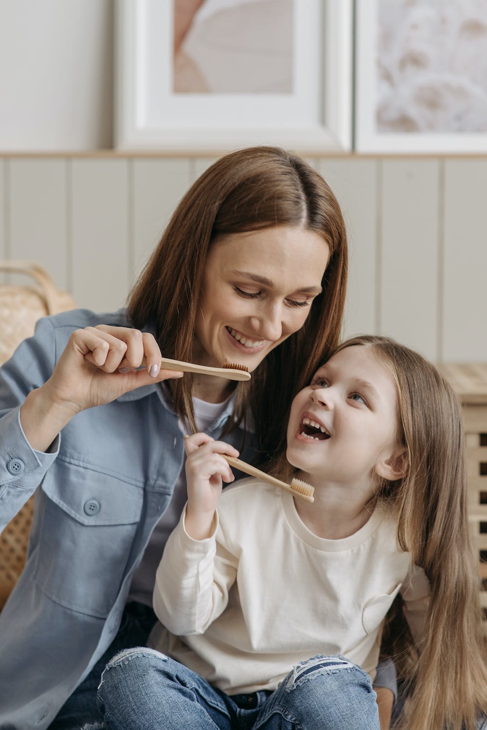 A mom and child brushing teeth