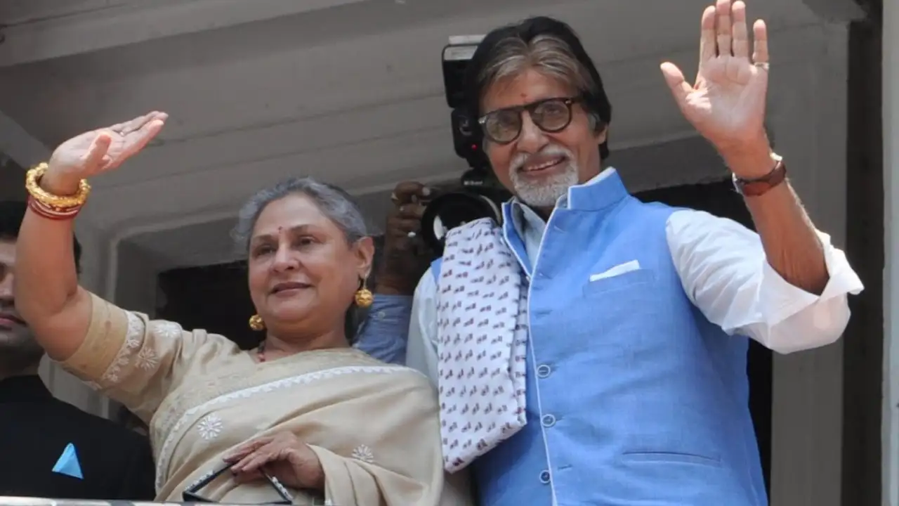 Amitabh Bachchan and Jaya Bachchan waving to fans. 