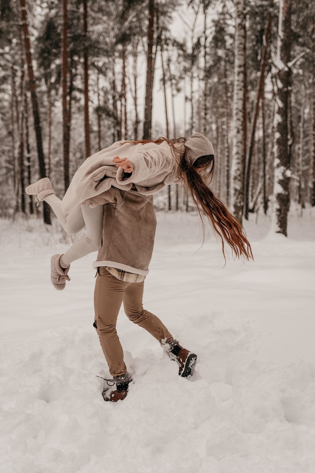 A teen couple playing in the snow for date night