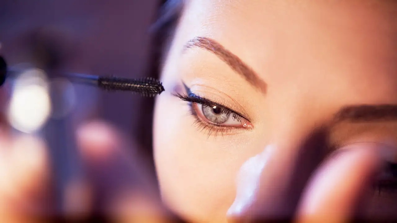 A woman using one of the Best Non-clumping Mascaras for Bold and Beautiful Eyes