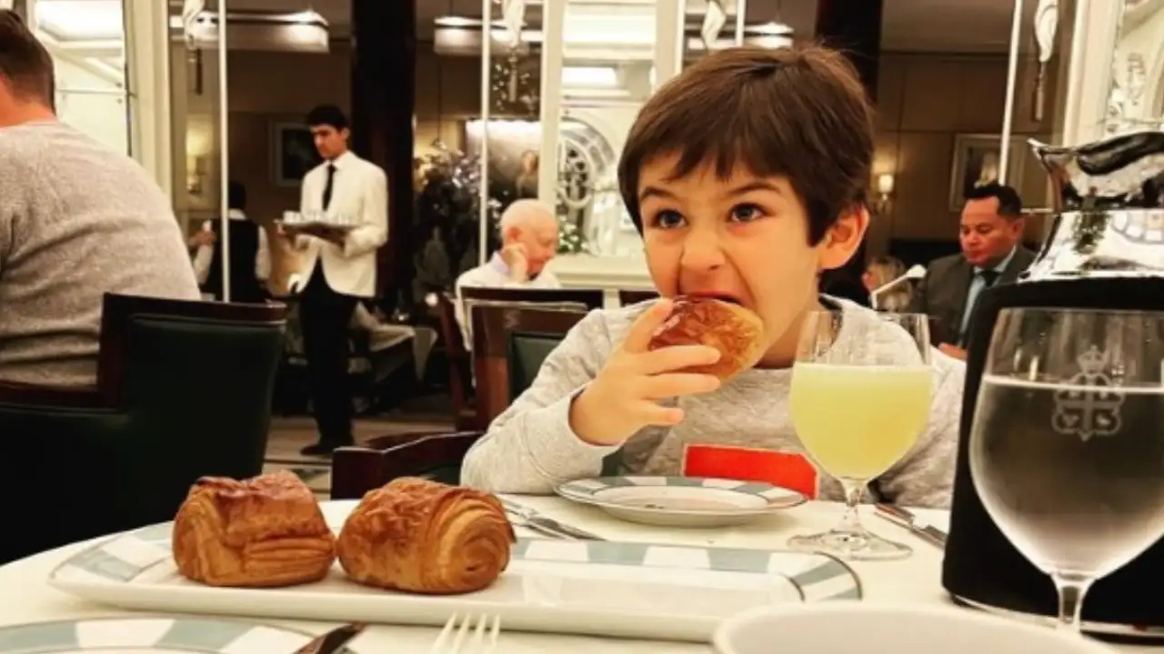 Taimur having croissant in a restaurant Taimur having croissant in a restaurant