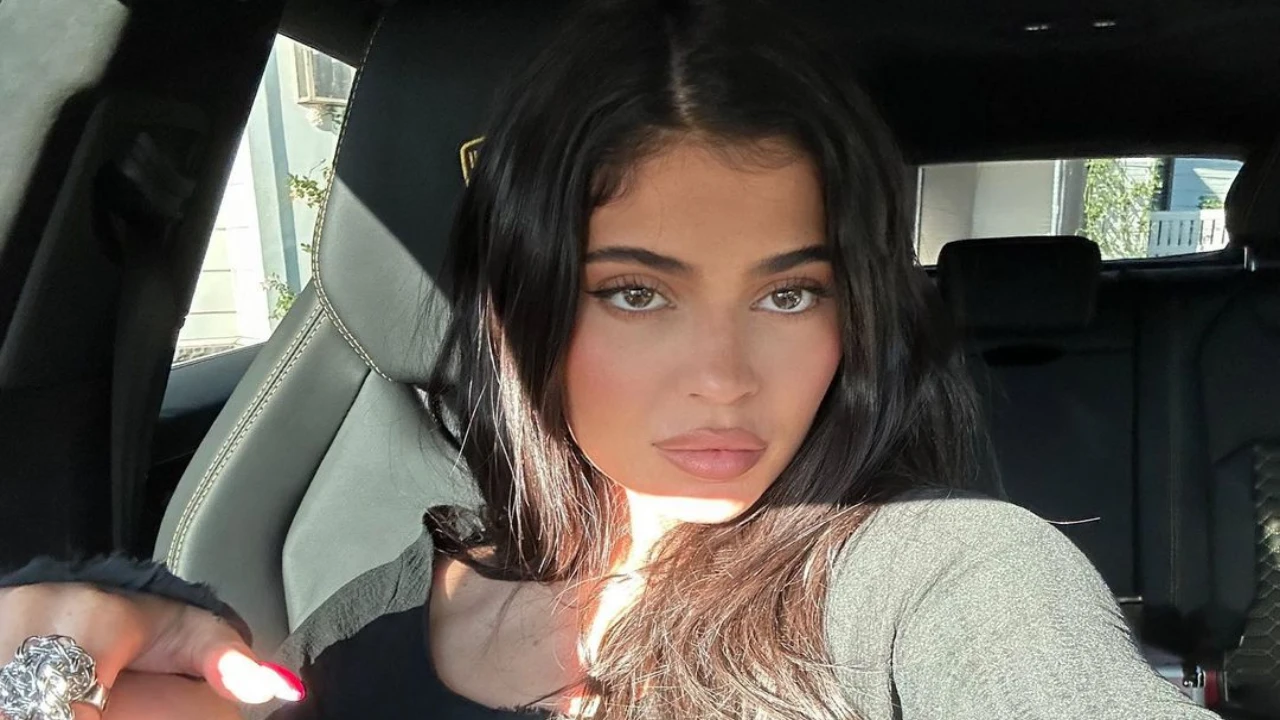 Kylie Jenner serves up high fashion as she rocks a black dress with a thigh-high slit;  see new pics