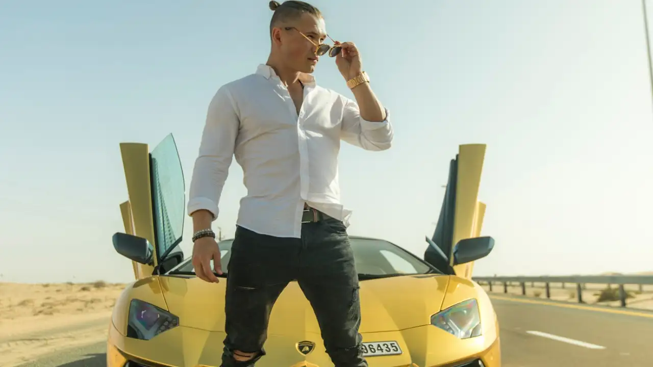 Man standing alongside his luxury car Pexels