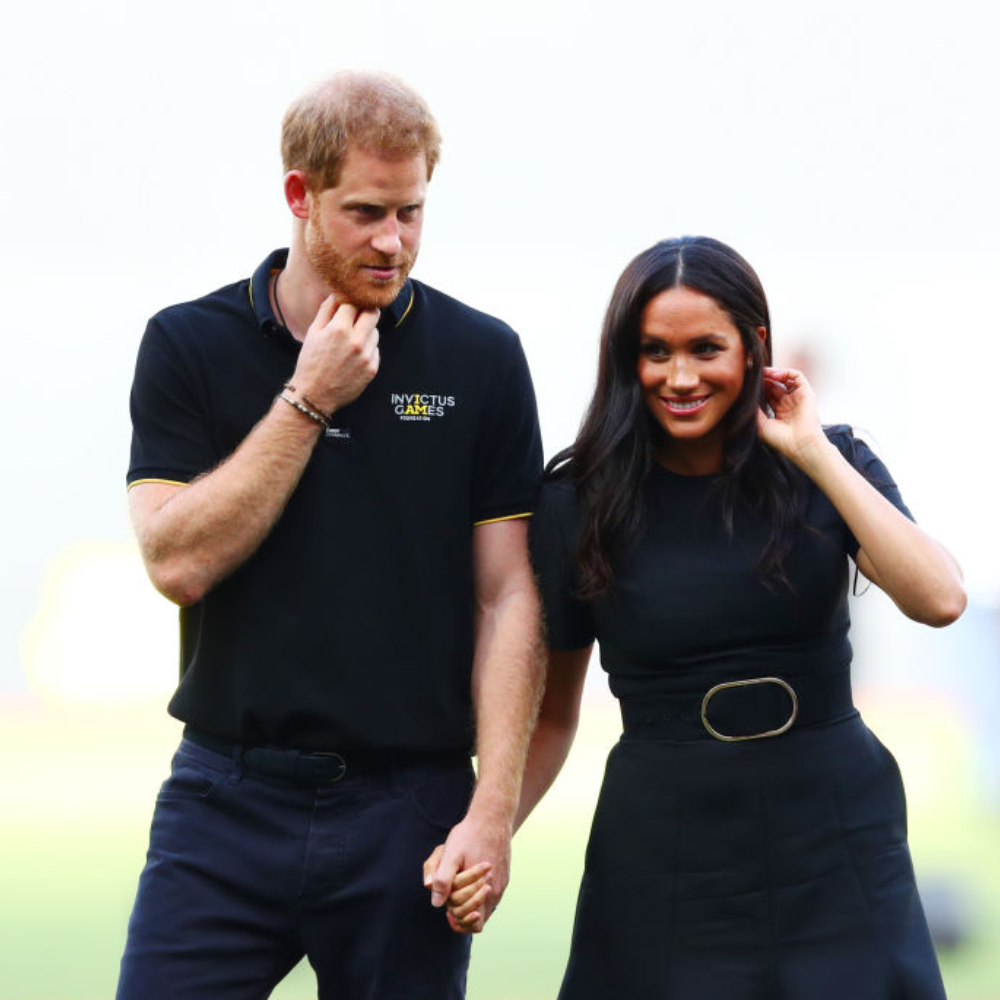 Prince Harry and Meghan Markle cook food as they volunteer for a rehab charity
