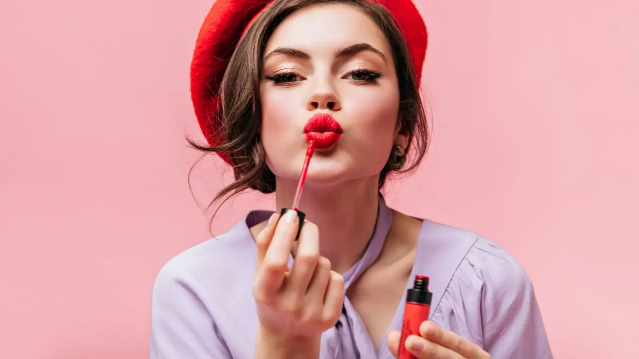 A woman applying a liquid lipstick