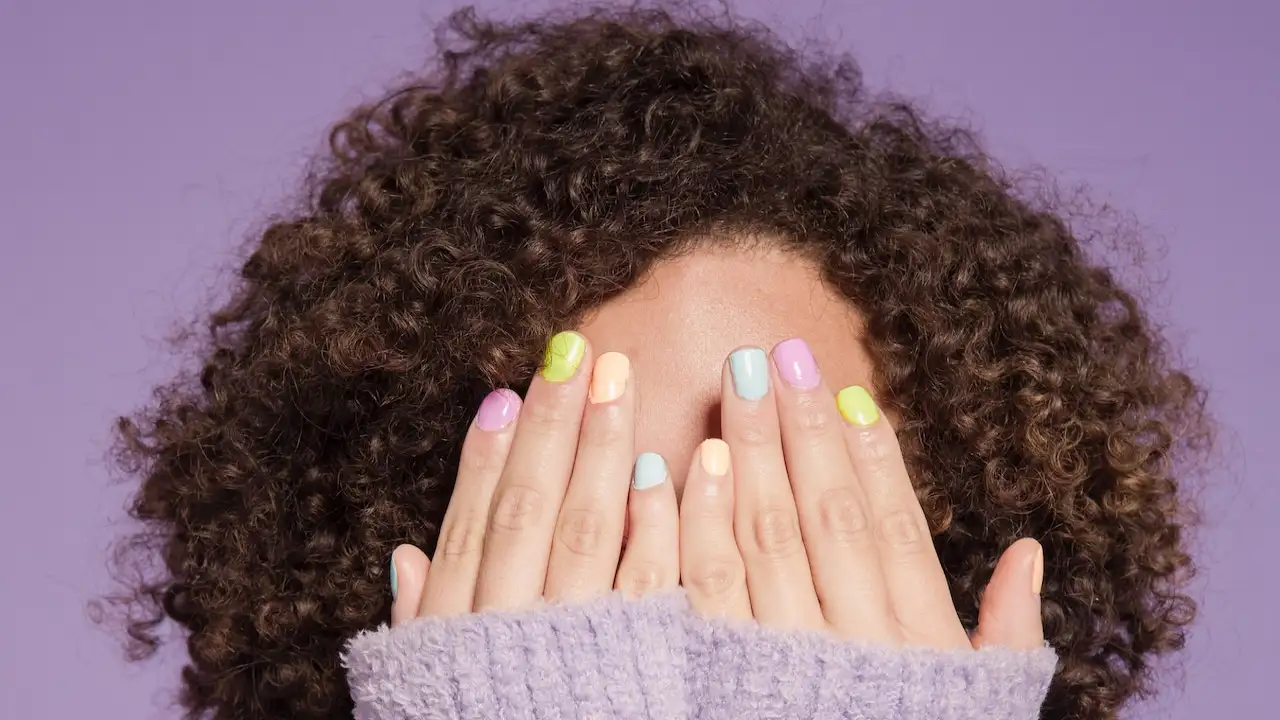 A woman with nails using one of the Best essie Nail Polish Colors to Add to Your Collection