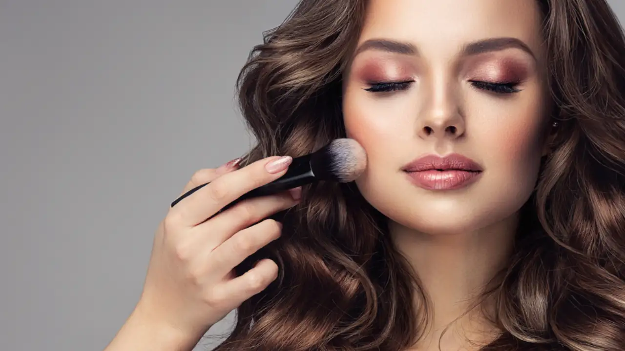 A woman using the Best Peach Blushes for a Warm Subtle Glow