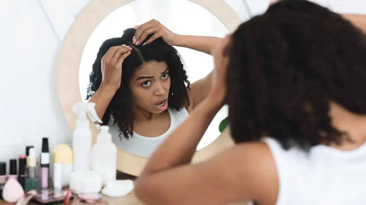 A woman using the Best Dandruff Shampoos for African Hair And Itchy Scalp