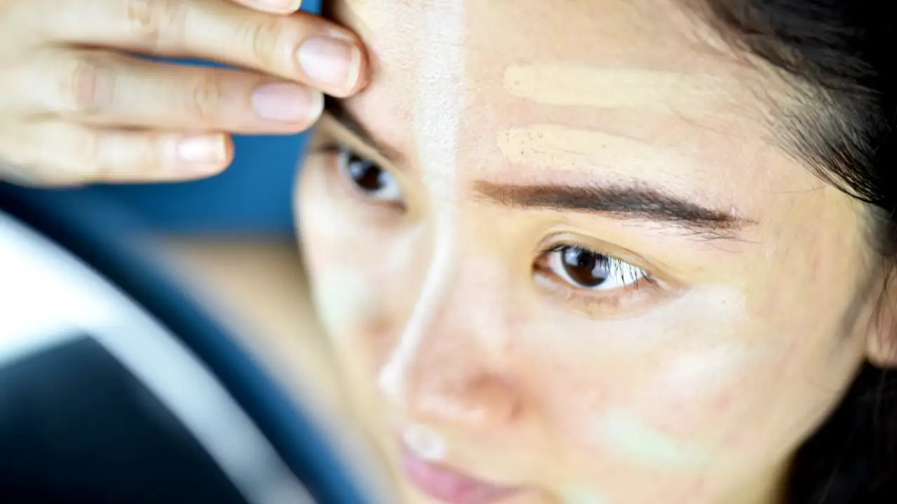 A woman applying one of the Best Concealers for Melasma