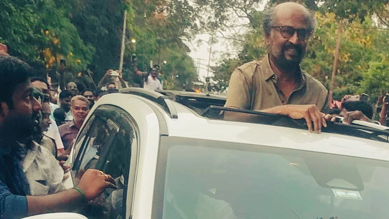 Indian actor Rajinikanth climbs on car roof, greets fans waiting outside Laal Salaam sets in Pondicherry.