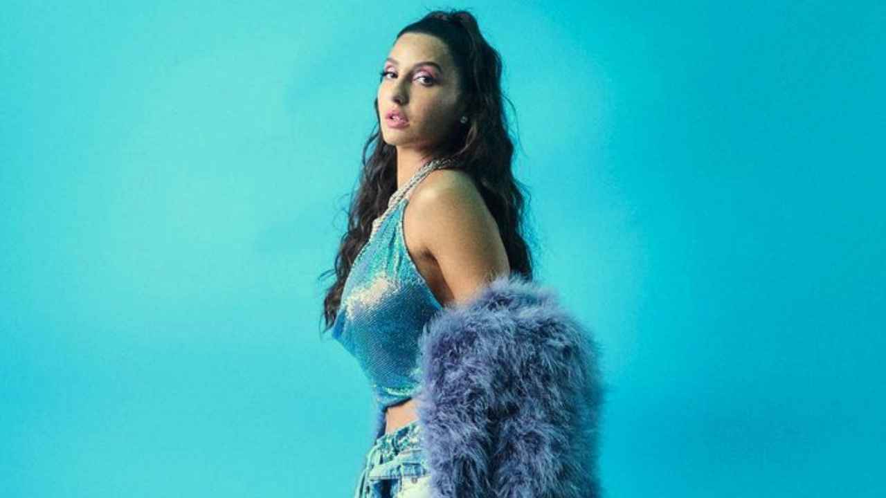 Nora Fatehi resembles modern princess Jasmine in blue fur coat with cowl-neck  halter top and denim jeans | PINKVILLA