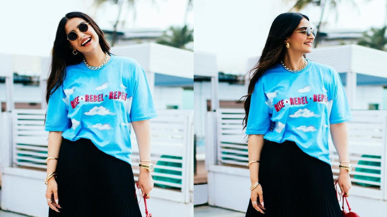 Sonam Kapoor rocks at a press event in a blue t-shirt with pleated skirt and golden accessories. (PC: Sonam Kapoor Instagram)