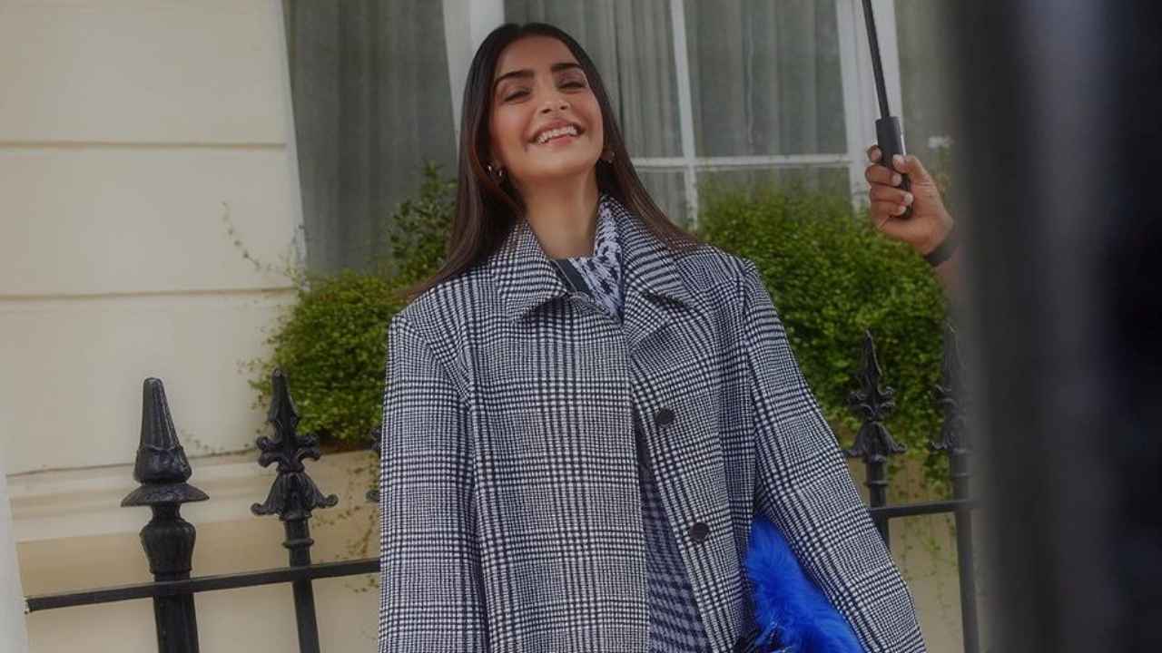 Sonam Kapoor Ahuja attends Burberry’s LFW show in their formal coat with sassy midi-dress, blue bag, and boots (PC: Sasha Jairam)