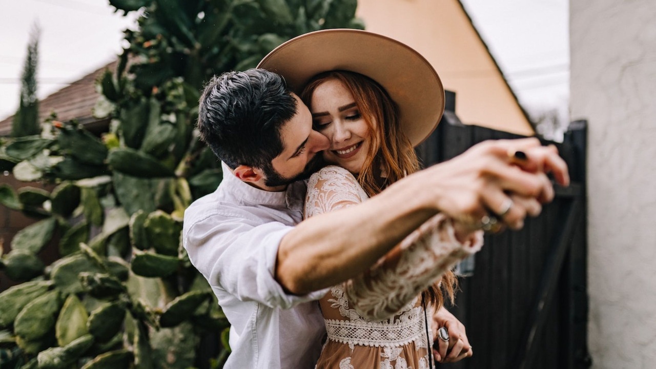 A Man Kissing a Woman in Her Cheek
