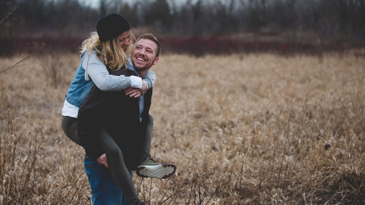 Photo of a Man Carrying His Partner