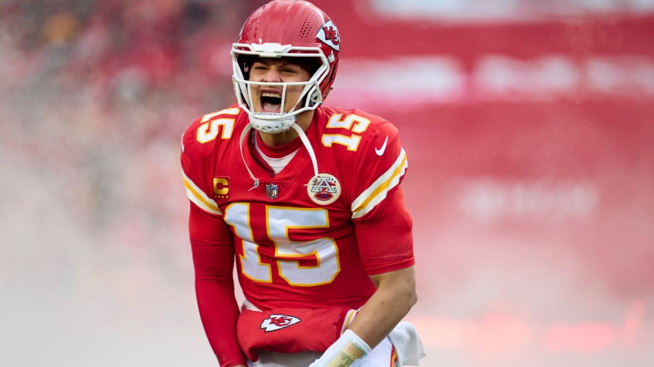 Why does Patrick Mahomes wear his helmet so high and wiggle his fingers between plays?