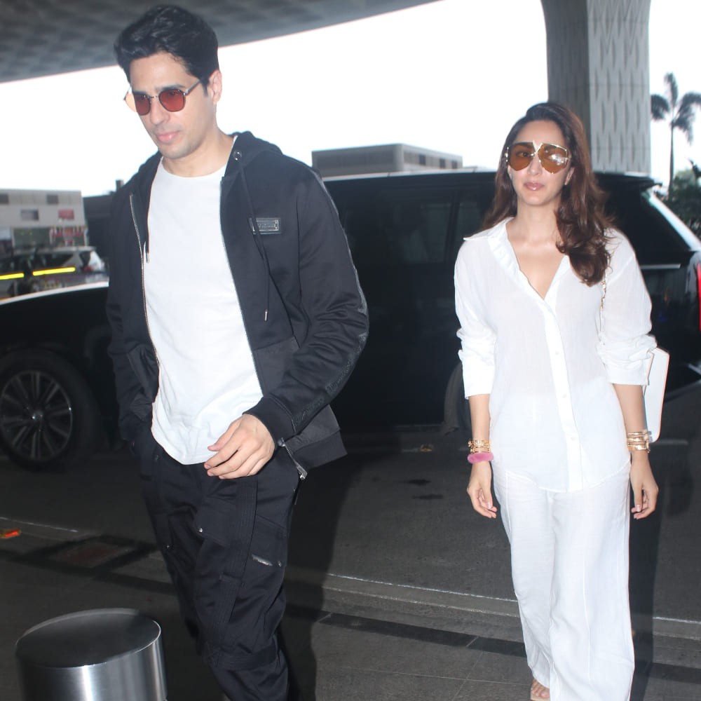 Kiara Advani brings monochrome magic to her airport style with a white shirt and wide-l...