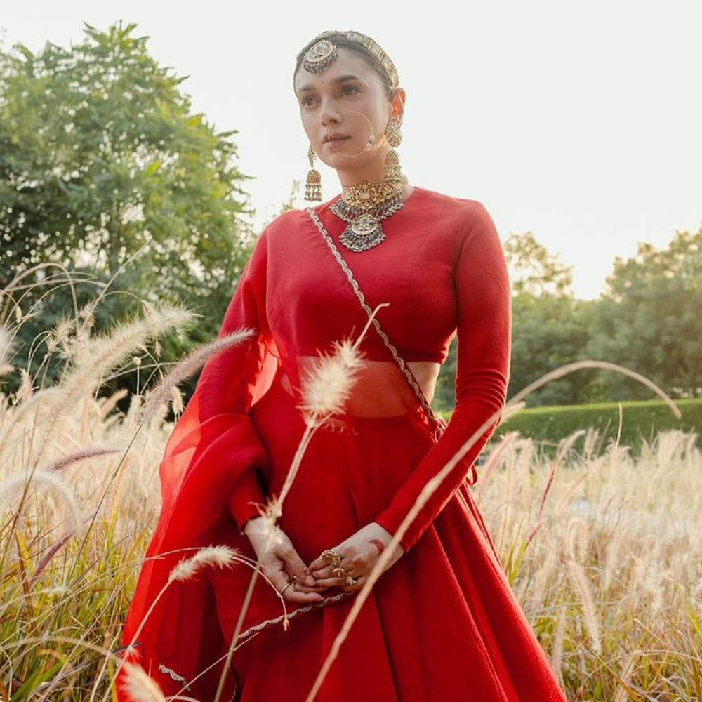 Aditi Rao Hydari wears Sabyasachi red lehenga drenched in heavily embellished jewelry f...
