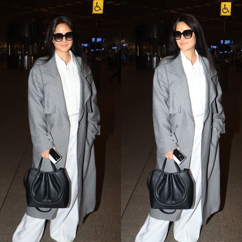 Katrina Kaif styles her classic white-on-white airport look with a trench coat and tint...