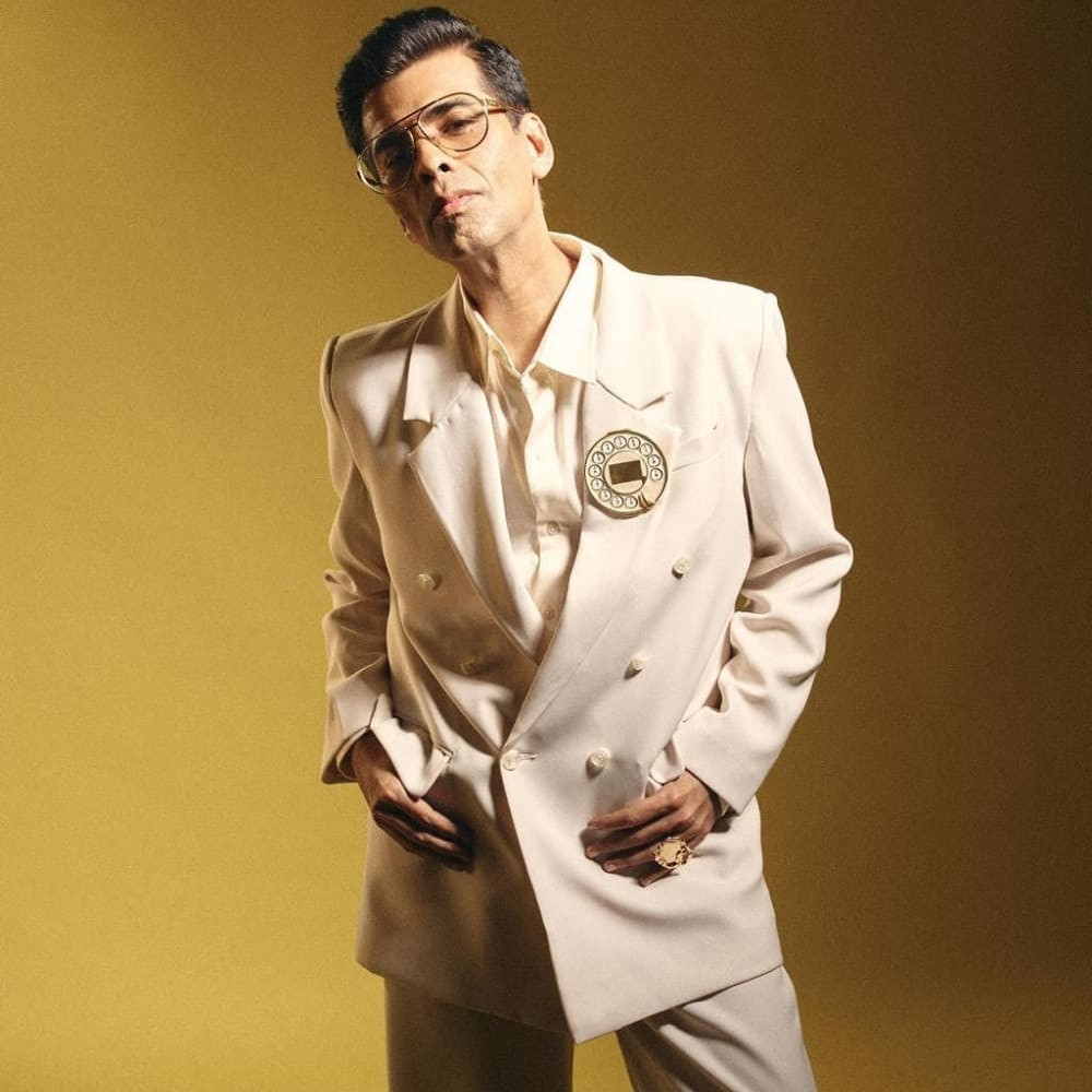 Karan Johar in Kanika Goyal’s suit turns retro tech into high fashion, pairing a teleph...
