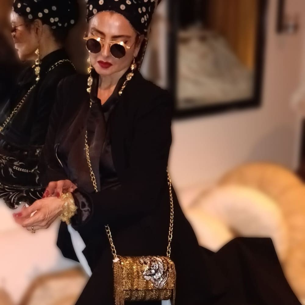Rekha pulls of vintage glam in black trench coat, skirt and shirt but it’s the headscarf that has our attention Rekha pulls of vintage glam in black trench coat, skirt and shirt but it’s the headscarf that has our attention