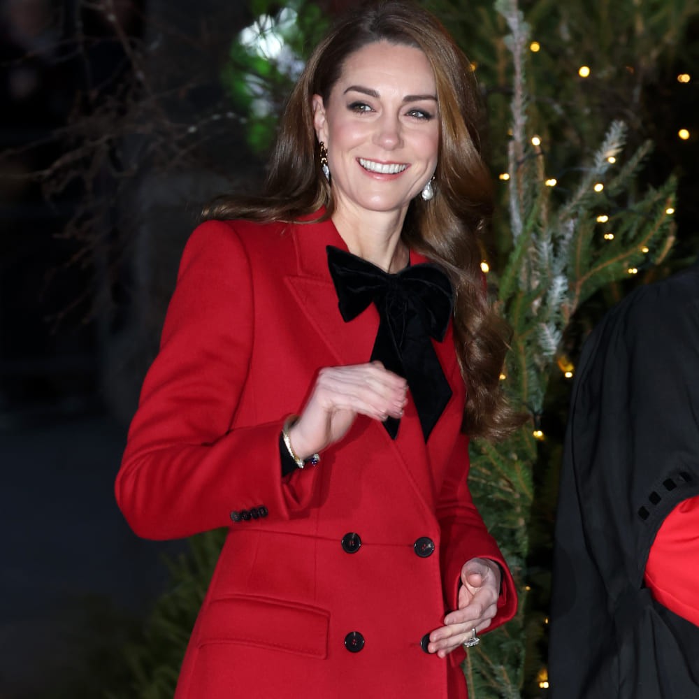Kate Middleton adds a coquette twist to her Christmas look with a black bow on her red peacoat  Kate Middleton adds a coquette twist to her Christmas look with a black bow on her red peacoat
