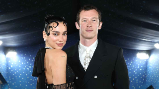 Dua Lipa and Callum Turner via Getty Images Getty Images