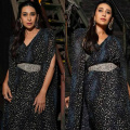 Karisma Kapoor is the picture of modern Indian elegance in a black fusion saree layered with gold tasseled cape