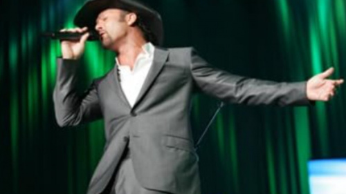 Tim McGraw performing on stage in 2025