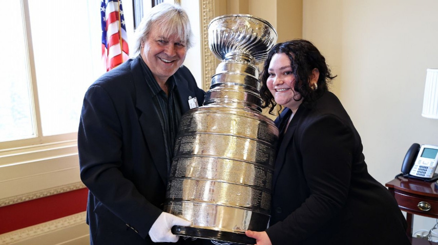 Nevada Congressional Delegation staff member poses with Phil Pritchard of the NHL Hall of Fame and the Stanley Cup [Credit-Getty Images]